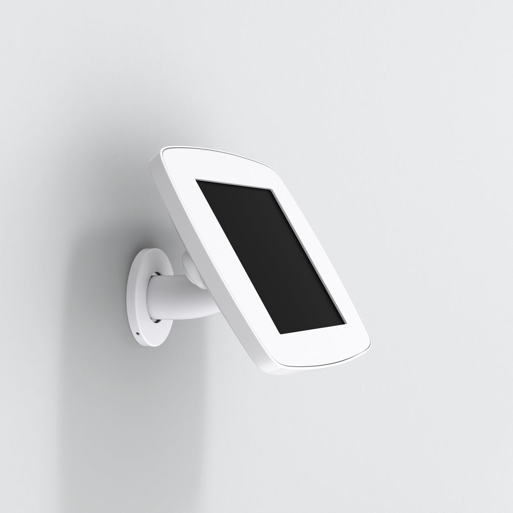 A white Bouncepad iPad wall mount mounted on a white wall, displaying an iPad in a vertical orientation.