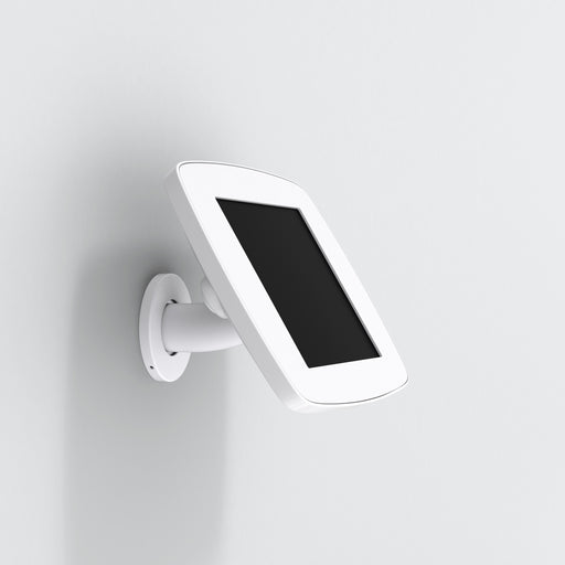 A white Bouncepad iPad wall mount mounted on a white wall, displaying an iPad in a vertical orientation.
